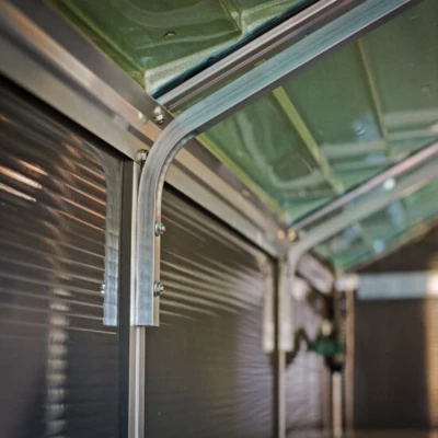 Canopia Rubicon Shed 185 × 229 cm (6 × 8 ft) on white background – dark grey panels, skylight roof, aluminium frame