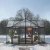 Triomphe 13×15 ft. Greenhouse by Canopia with black frame and clear acrylic walls