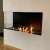 Foco Corner Left 1200 - Modern corner bioethanol fireplace with a sleek black frame and vibrant flames.